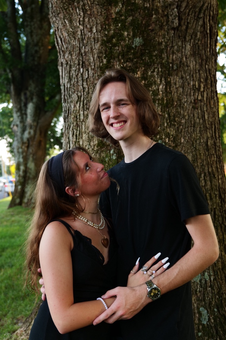 Couple smiling by a tree