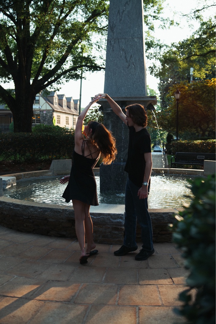 Couple dancing at a fountain