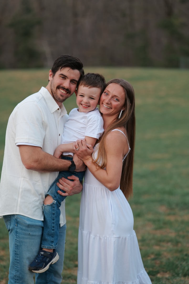 Happy family of three in white outfits