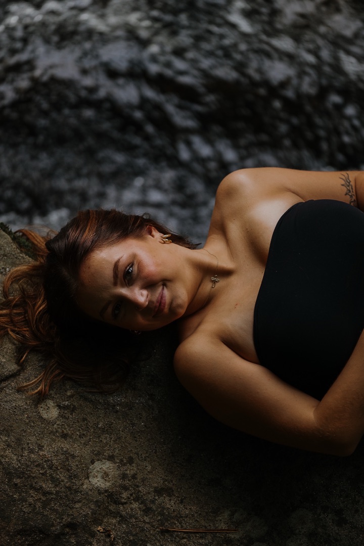 Portrait by waterfall on rocks