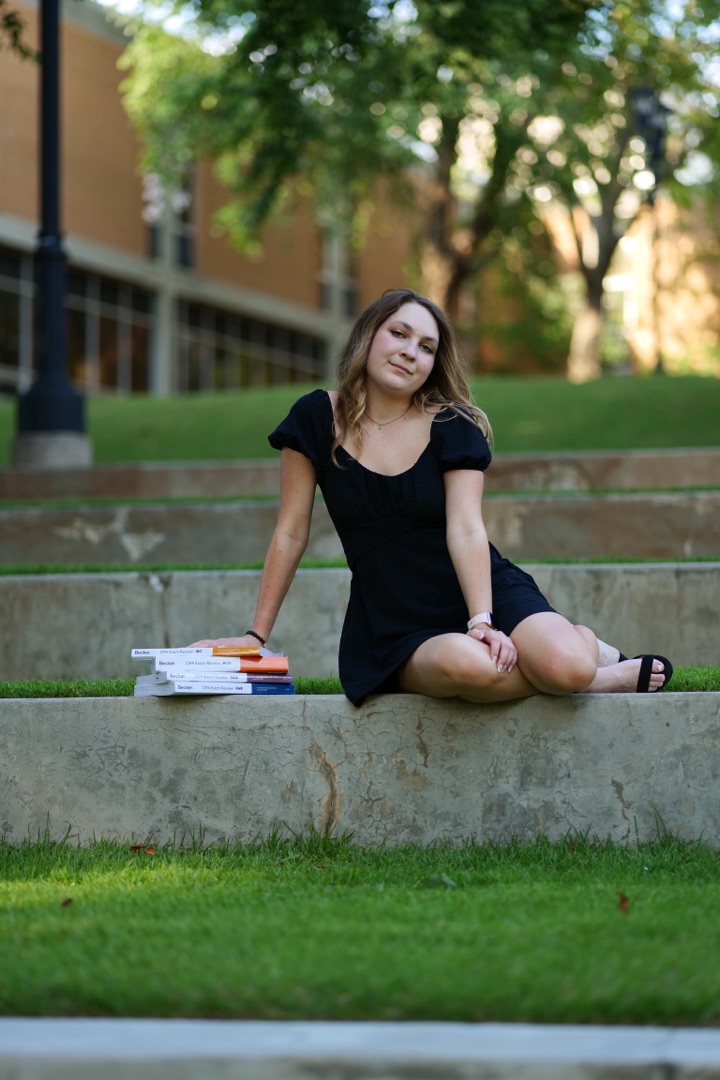 Senior portrait sitting on campus steps